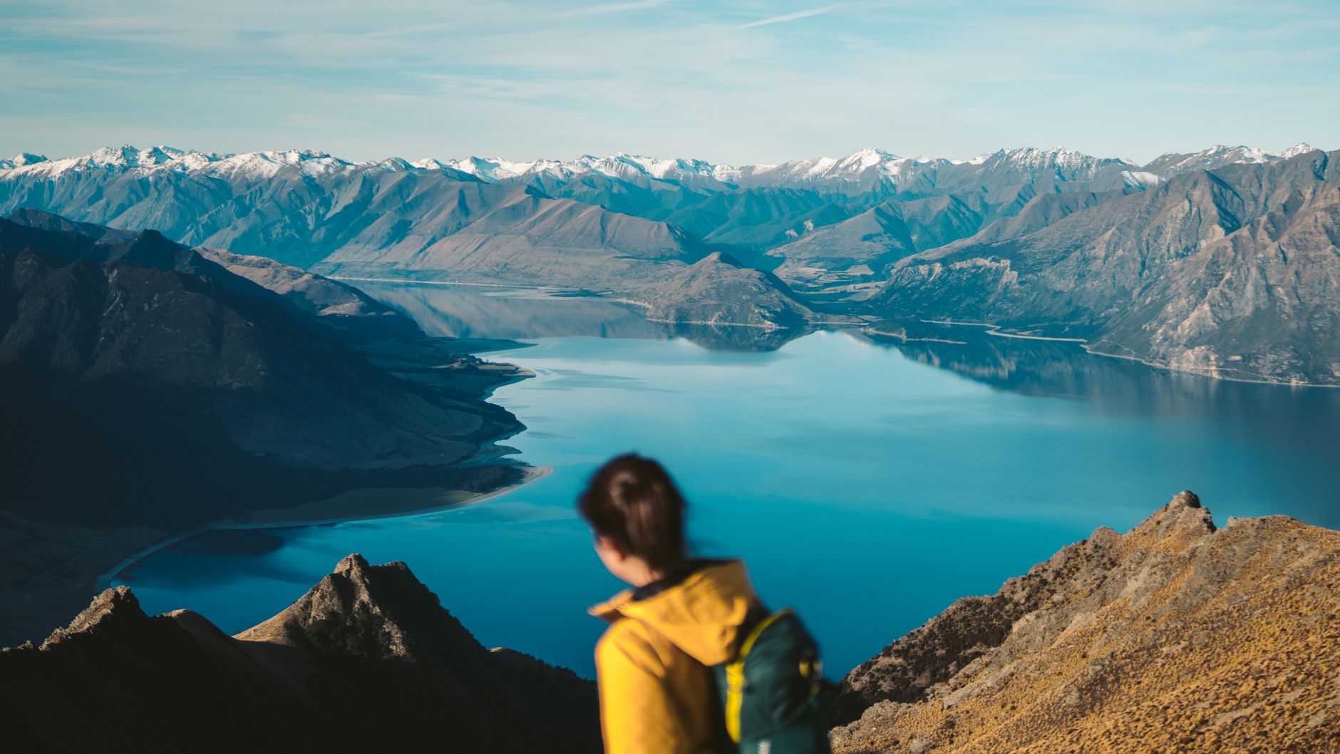 Hiker looking across New Zealand mountain ridge